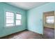 Bedroom with hardwood floors, two bright windows and door frame at 1445 Saint Paul St, Denver, CO 80206