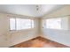 A bedroom featuring a window and hardwood flooring at 1445 Saint Paul St, Denver, CO 80206