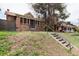 View of the front exterior of the red brick home and steps leading to the entrance at 1445 Saint Paul St, Denver, CO 80206
