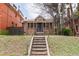 Charming brick home with a welcoming front porch and steps leading to the entrance at 1445 Saint Paul St, Denver, CO 80206