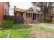 Charming brick home featuring a cozy front porch and adjacent wooden fence at 1445 Saint Paul St, Denver, CO 80206