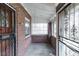 Enclosed front porch featuring brick walls, concrete floor, and decorative metal grates at 1445 Saint Paul St, Denver, CO 80206