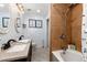 An airy bathroom offers double sinks, granite countertops, tile flooring, and a shower-tub combo at 302 Texas Dr, Idaho Springs, CO 80452