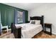 This charming bedroom includes a full bed, side tables, accent wall, and large windows at 302 Texas Dr, Idaho Springs, CO 80452