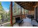 Inviting covered deck with seating area, offering a peaceful retreat with beautiful views of the surrounding forest at 302 Texas Dr, Idaho Springs, CO 80452
