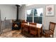 Cozy dining area with wood-burning stove and nature views at 302 Texas Dr, Idaho Springs, CO 80452