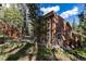 Charming home nestled among tall trees, featuring a rustic exterior and inviting wooden decks at 302 Texas Dr, Idaho Springs, CO 80452