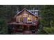 Charming cabin-style home with a large deck nestled in a lush, wooded setting at 302 Texas Dr, Idaho Springs, CO 80452