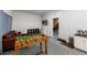 Spacious game room featuring a foosball table, comfortable sofa, and entertainment area at 302 Texas Dr, Idaho Springs, CO 80452