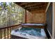 Relaxing hot tub on the deck surrounded by lush trees, perfect for unwinding after a long day at 302 Texas Dr, Idaho Springs, CO 80452