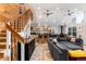 Spacious open-concept living area features vaulted ceilings, a cozy sectional, and natural light at 302 Texas Dr, Idaho Springs, CO 80452
