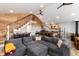Open-concept living space with wood accents and a large gray sectional sofa at 302 Texas Dr, Idaho Springs, CO 80452