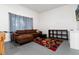 Relaxing living area featuring a sectional sofa, patterned rug, and natural light from the window at 302 Texas Dr, Idaho Springs, CO 80452