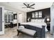 A spacious primary bedroom features a mirrored closet, king bed, bench and ceiling fan at 302 Texas Dr, Idaho Springs, CO 80452