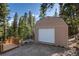 Convenient shed with a large door and a small deck, providing ample storage and utility space at 302 Texas Dr, Idaho Springs, CO 80452