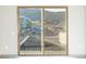 Sliding glass door reveals a view of the building's exterior and surrounding mountain landscape at 12983 W Ida Ave # 300, Littleton, CO 80127