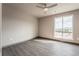 Bright bedroom with large window and ceiling fan at 12983 W Ida Ave # 300, Littleton, CO 80127