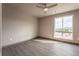 Spacious bedroom with ceiling fan and large window offering mountain views at 12983 W Ida Ave # 300, Littleton, CO 80127