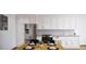 Modern kitchen with stainless steel appliances and white cabinets at 12983 W Ida Ave # 300, Littleton, CO 80127