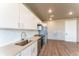 Modern kitchen with stainless steel appliances and white cabinetry at 12983 W Ida Ave # 300, Littleton, CO 80127