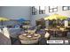 Relaxing outdoor patio with tables, chairs, and umbrellas at 12983 W Ida Ave # 300, Littleton, CO 80127