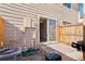 This back patio features an entrance to the house with a sliding glass door and a wooden fence at 8975 Field St # 39, Broomfield, CO 80021