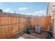 View of the fenced backyard with grassy lawn and view of side of the house at 8975 Field St # 39, Broomfield, CO 80021