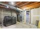 Unfinished basement featuring modern washer and dryer with an exposed ceiling, furnace, and doorway at 8975 Field St # 39, Broomfield, CO 80021