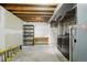 Unfinished basement with wood ceilings and concrete floor features shelves and a table at 8975 Field St # 39, Broomfield, CO 80021