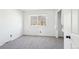 Bright bedroom with neutral carpet, a window, and closet space with white curtains at 8975 Field St # 39, Broomfield, CO 80021