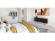 This staged bedroom features a mid-century modern console and tasteful decor at 8975 Field St # 39, Broomfield, CO 80021