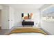 This staged bedroom features a mid-century modern console and tasteful decor at 8975 Field St # 39, Broomfield, CO 80021