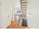 Hallway with stairway to the right, door to the left, and living room in the background at 8975 Field St # 39, Broomfield, CO 80021