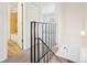Upstairs hallway shows bathroom and bedroom entrances and staircase at 8975 Field St # 39, Broomfield, CO 80021