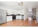 Well-lit kitchen featuring white cabinetry, stainless appliances, and hardwood floors at 8975 Field St # 39, Broomfield, CO 80021