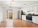 Clean kitchen with white cabinets, stainless steel appliances, and dining area at 8975 Field St # 39, Broomfield, CO 80021