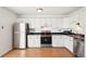 This updated kitchen boasts stainless steel appliances, white cabinets, and dark countertops at 8975 Field St # 39, Broomfield, CO 80021