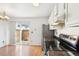 Kitchen area includes stainless steel appliances, sliding door to the outside and light wood flooring at 8975 Field St # 39, Broomfield, CO 80021