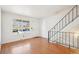 Inviting living room featuring hardwood floors, staircase, and natural light at 8975 Field St # 39, Broomfield, CO 80021