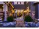 Elegant back entrance with stone accents, sliding glass doors, and landscaped steps at 8661 Hunters Hill Ln, Littleton, CO 80125
