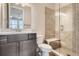Bathroom with a gray vanity, granite countertop, toilet, and clear glass shower with a built in bench at 8661 Hunters Hill Ln, Littleton, CO 80125