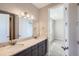 Bathroom with double vanity, granite counters and access to a bedroom at 8661 Hunters Hill Ln, Littleton, CO 80125