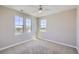 Empty bedroom with neutral walls and carpet, ceiling fan, and good natural light at 8661 Hunters Hill Ln, Littleton, CO 80125