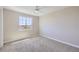 Bright bedroom featuring neutral walls, carpet, and a window offering scenic outdoor views at 8661 Hunters Hill Ln, Littleton, CO 80125