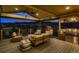 Luxurious covered deck featuring an outdoor kitchen, ample seating, and stunning mountain views at 8661 Hunters Hill Ln, Littleton, CO 80125