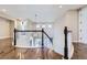 Bright hallway with dark wood floors, dark and white railing, and high ceilings at 8661 Hunters Hill Ln, Littleton, CO 80125