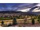 Picturesque landscape view with rolling hills and a community of homes nestled in the distance at 8661 Hunters Hill Ln, Littleton, CO 80125