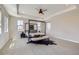 Bright main bedroom with ceiling fan, carpet floors, tray ceilings and mountain views at 8661 Hunters Hill Ln, Littleton, CO 80125
