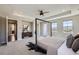 Bright main bedroom with ceiling fan, carpet floors, views and ensuite bathroom at 8661 Hunters Hill Ln, Littleton, CO 80125