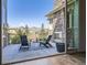 Outdoor patio with mountain views, seating area, and stone fireplace at 8661 Hunters Hill Ln, Littleton, CO 80125